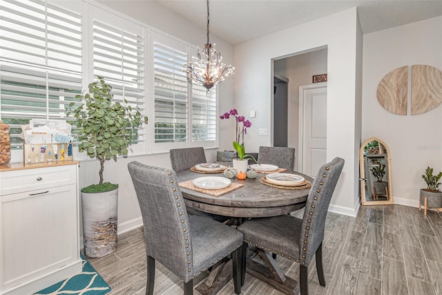 dining room featuring a notable chandelier and light wood-type flooring