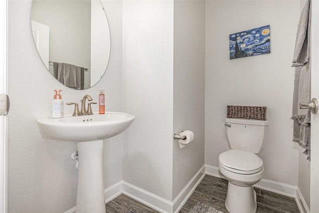 bathroom featuring toilet and hardwood / wood-style flooring