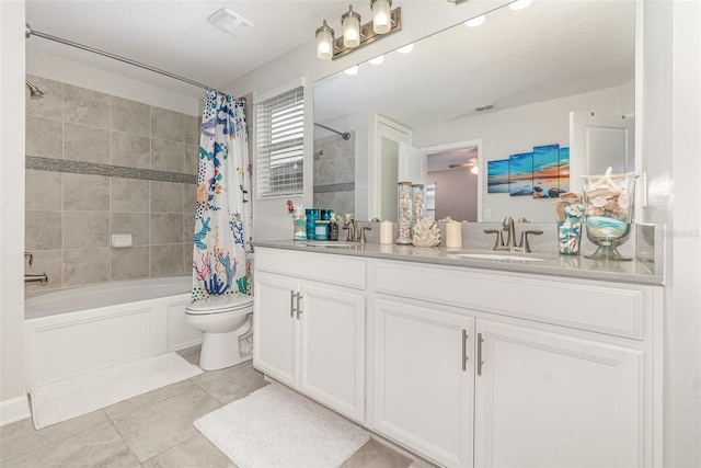 full bathroom with vanity, tile patterned floors, shower / bath combination with curtain, toilet, and a textured ceiling