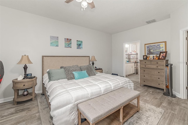 bedroom with ceiling fan, ensuite bathroom, and light hardwood / wood-style flooring