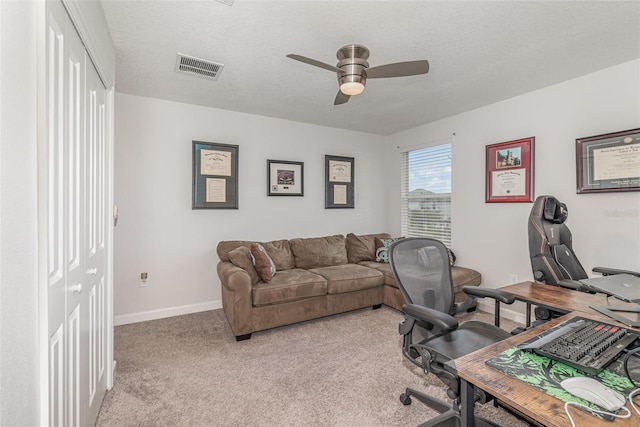 office with ceiling fan, light colored carpet, and a textured ceiling