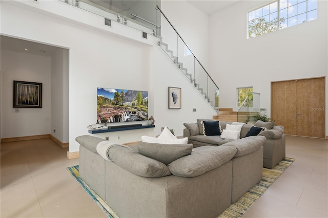 tiled living room featuring a towering ceiling