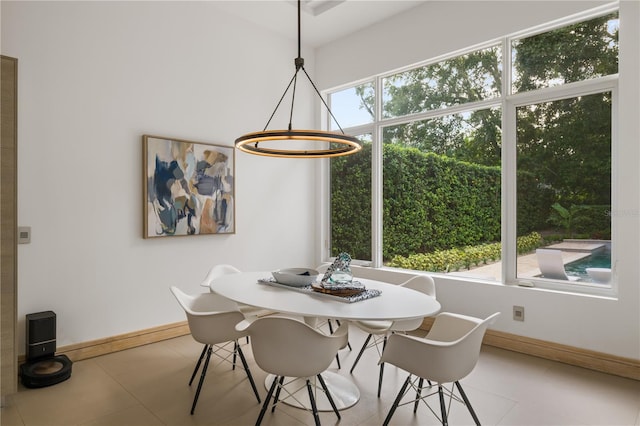 dining space with an inviting chandelier and light tile patterned floors