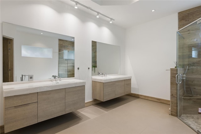 bathroom with vanity, walk in shower, and tile patterned flooring