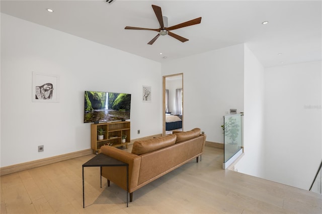 living room featuring ceiling fan and light hardwood / wood-style flooring