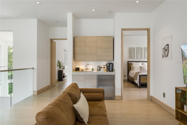 living room with sink and light wood-type flooring