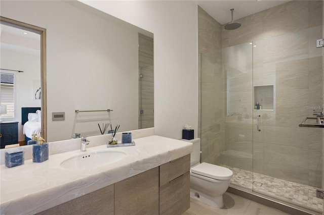 bathroom with vanity, tile patterned flooring, toilet, and walk in shower