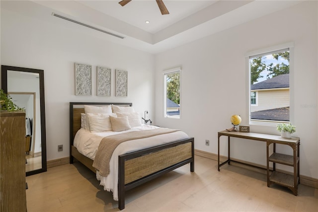 bedroom featuring multiple windows, light wood-type flooring, and ceiling fan