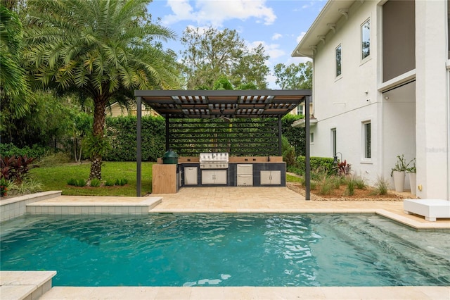 view of swimming pool with exterior kitchen, area for grilling, and a pergola