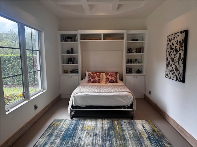 bedroom with beamed ceiling, coffered ceiling, and multiple windows