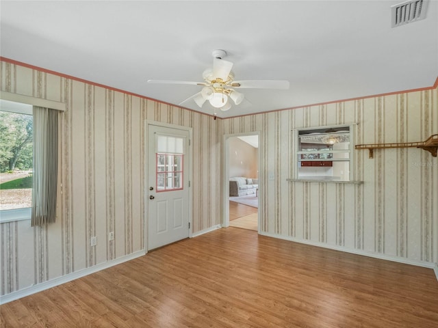 spare room featuring light wood-type flooring and ceiling fan