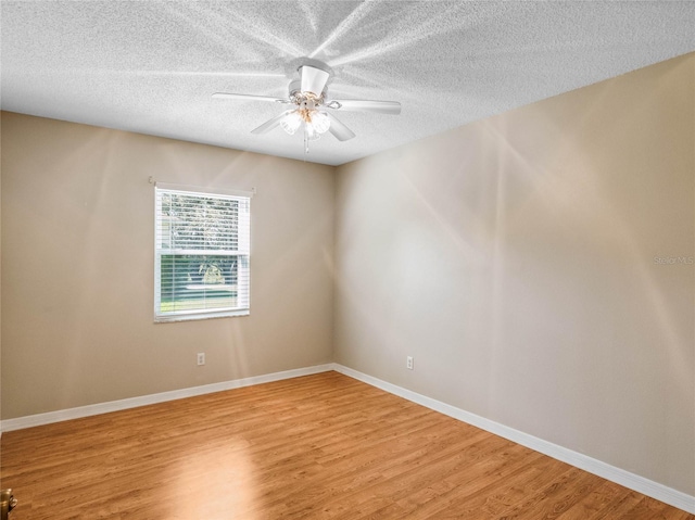 unfurnished room with light hardwood / wood-style flooring, a textured ceiling, and ceiling fan