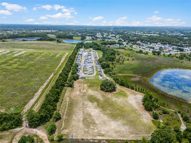 birds eye view of property with a water view and a rural view