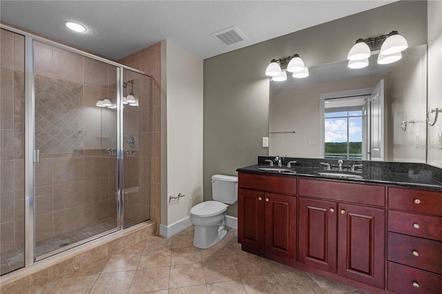 bathroom featuring vanity, toilet, tile patterned floors, and walk in shower