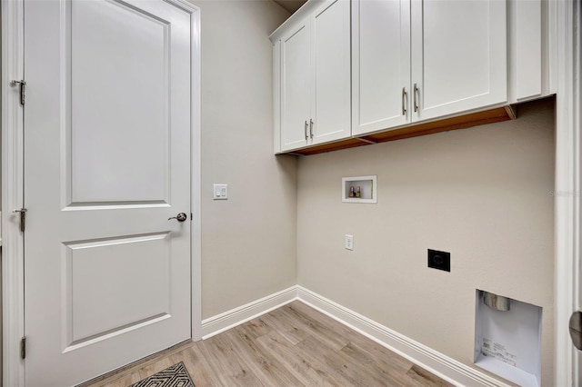 washroom with hookup for an electric dryer, hookup for a washing machine, light hardwood / wood-style flooring, and cabinets