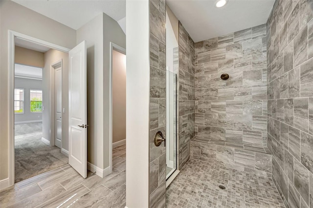 bathroom with a tile shower