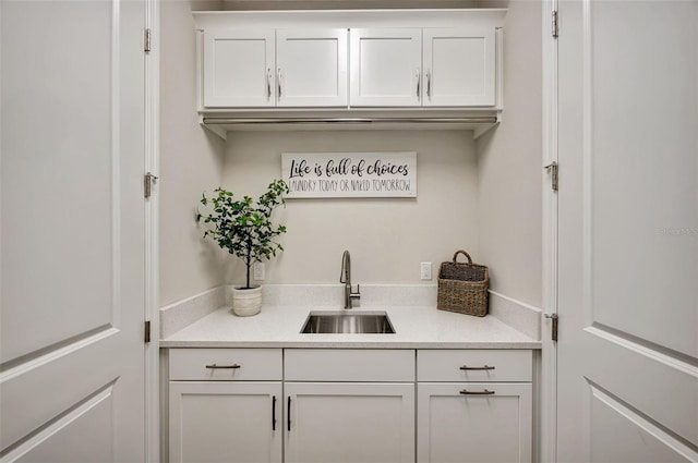 bar with sink and white cabinets