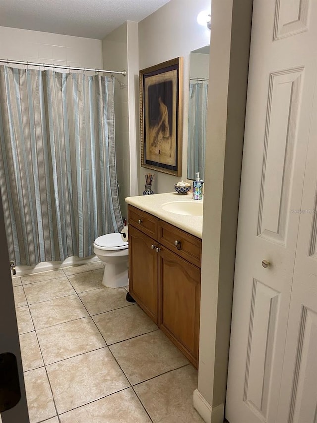 full bathroom with a shower with shower curtain, vanity, toilet, and tile patterned floors