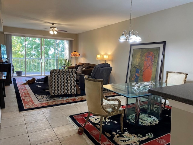 dining space with light tile patterned floors and ceiling fan with notable chandelier