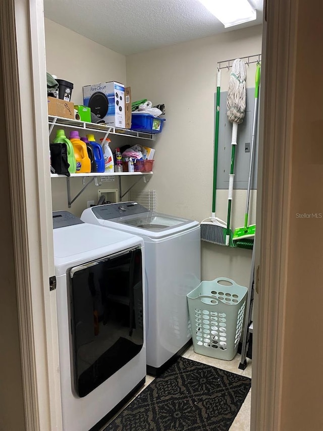 laundry room with a textured ceiling, laundry area, and washing machine and dryer