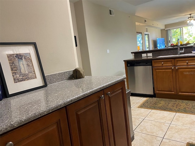 kitchen featuring light tile patterned floors, visible vents, dishwasher, ceiling fan, and a sink