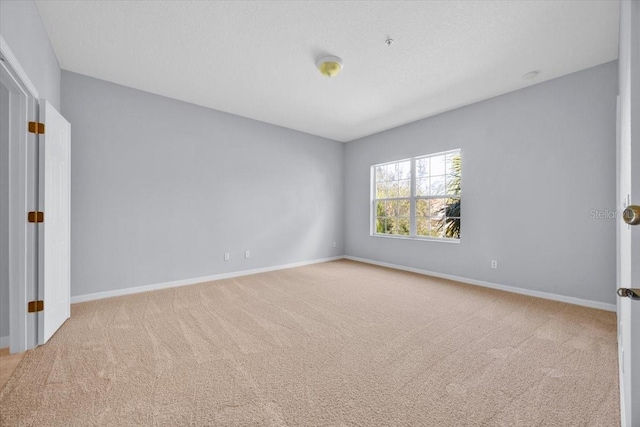 empty room featuring light carpet