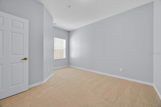 empty room featuring light carpet