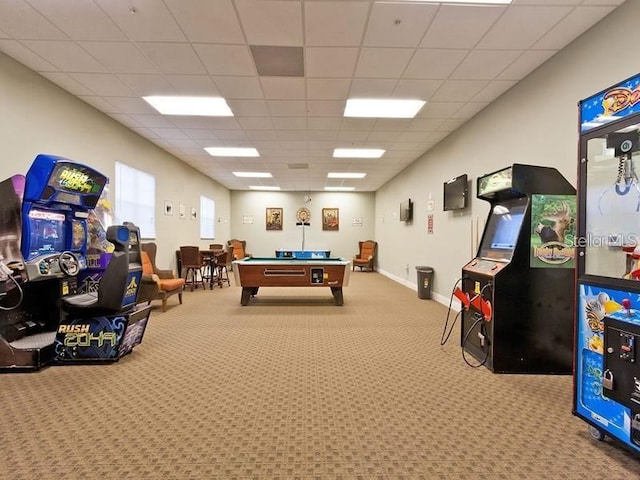 recreation room featuring carpet floors and a paneled ceiling