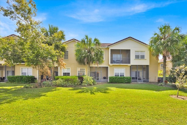 rear view of property with a yard