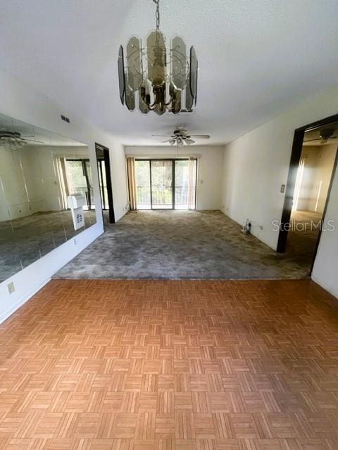 unfurnished room with a notable chandelier and light parquet flooring