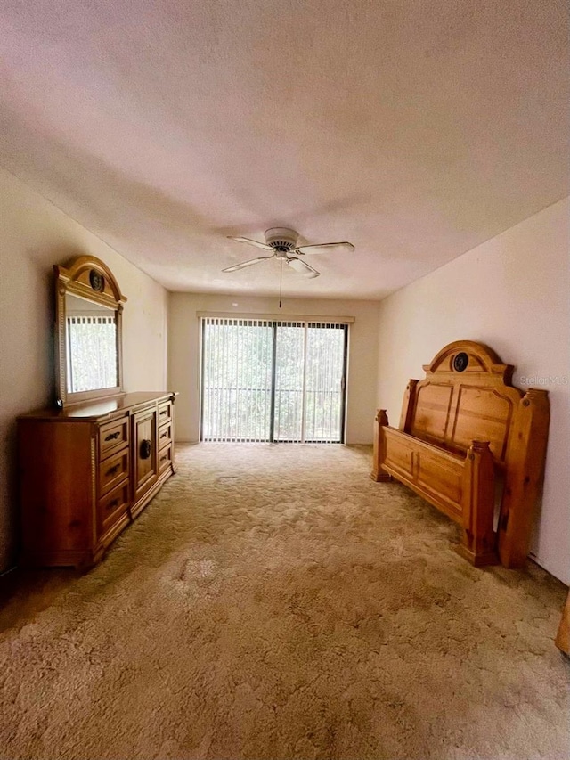 living room featuring ceiling fan, a textured ceiling, light colored carpet, and plenty of natural light