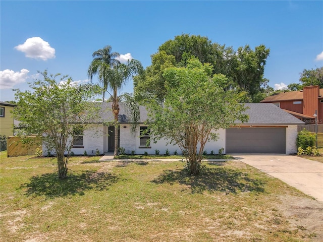 view of front of house with a front yard and a garage