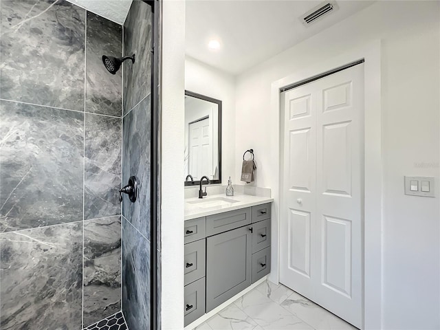 bathroom featuring vanity and a tile shower