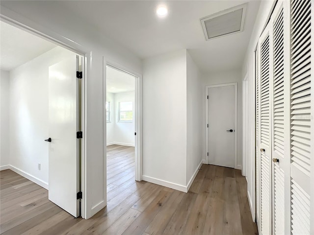 hallway with light hardwood / wood-style flooring