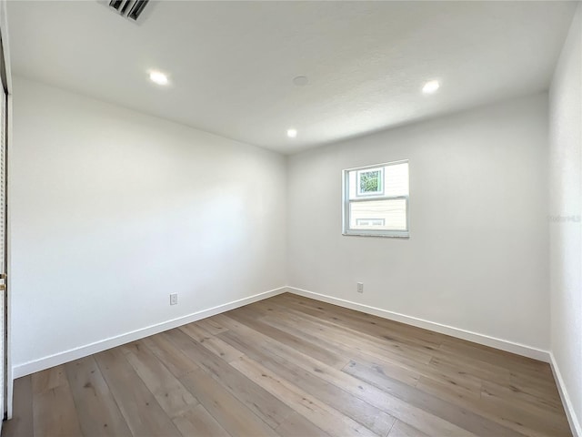 spare room with light wood-type flooring