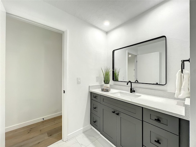 bathroom featuring vanity and wood-type flooring