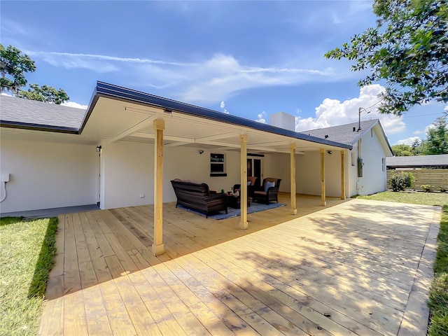 rear view of property with an outdoor living space and a deck