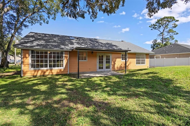 back of house featuring a patio area, french doors, and a yard