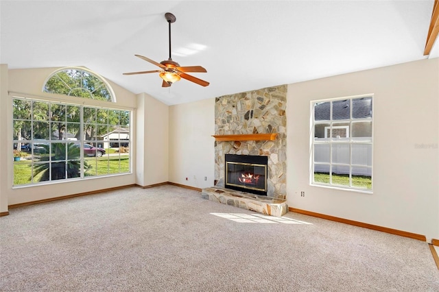 unfurnished living room with vaulted ceiling, a fireplace, carpet floors, and ceiling fan