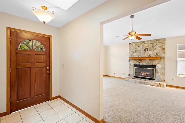 entryway with light carpet, a fireplace, plenty of natural light, and ceiling fan