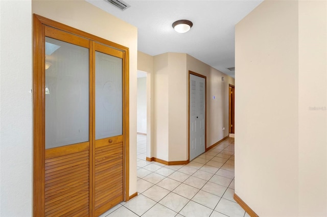 hall with light tile patterned floors