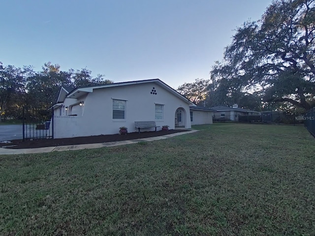 view of home's exterior with a lawn