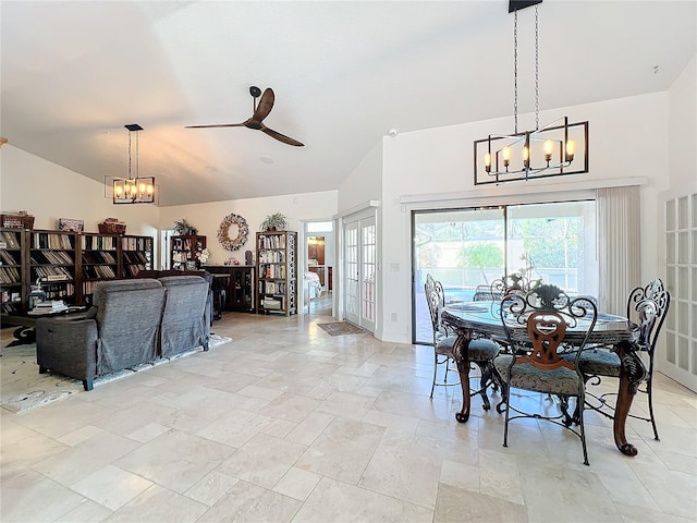 dining space featuring french doors, ceiling fan with notable chandelier, and vaulted ceiling