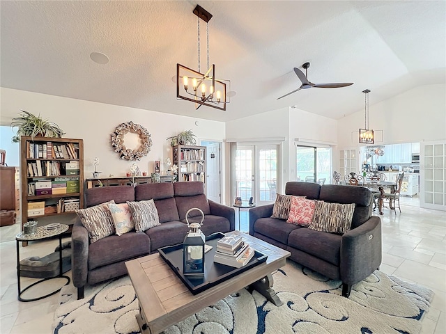 tiled living room with a textured ceiling, vaulted ceiling, ceiling fan with notable chandelier, and french doors