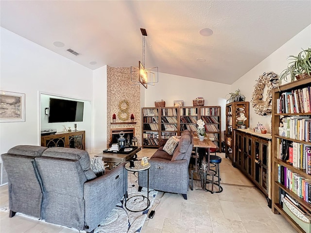 living room featuring a chandelier and lofted ceiling