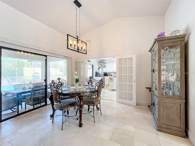 dining room with lofted ceiling and a notable chandelier