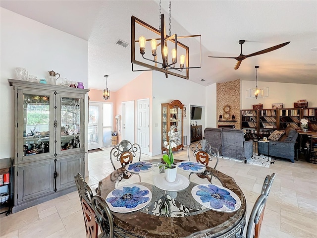 dining area with lofted ceiling and ceiling fan with notable chandelier