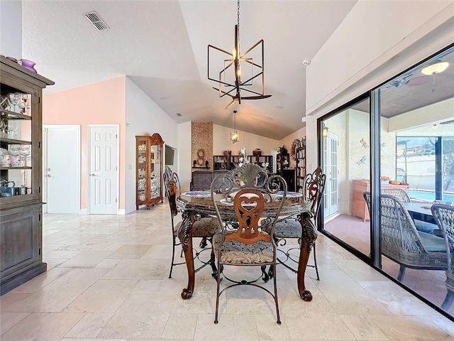 dining space featuring vaulted ceiling and a notable chandelier