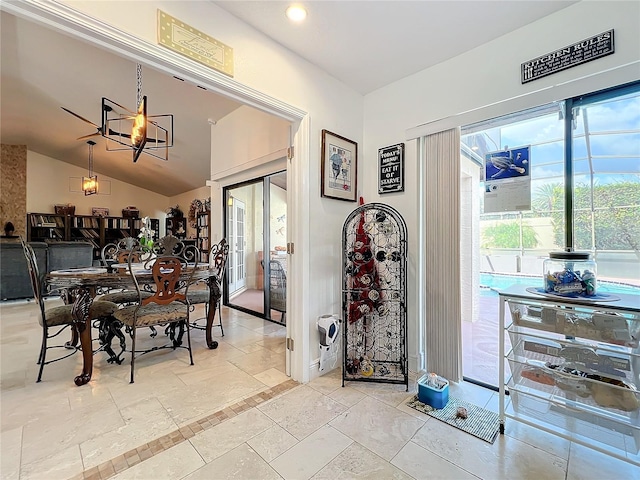 dining space with lofted ceiling and a notable chandelier