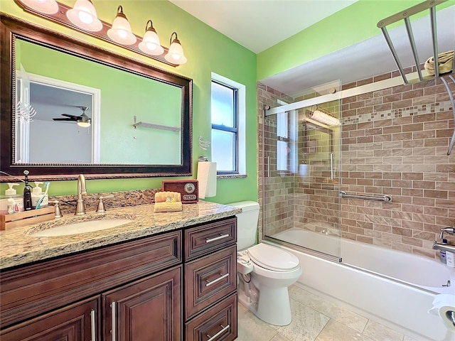 full bathroom featuring tile patterned flooring, enclosed tub / shower combo, ceiling fan, vanity, and toilet